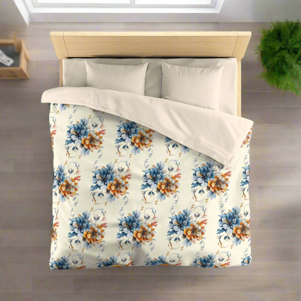 A duvet cover with a floral pattern, featuring large colorful flowers on a light background, displayed on a bed with pillows.