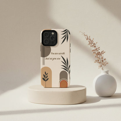 Phone case with leaf design and motivational quote on beige background