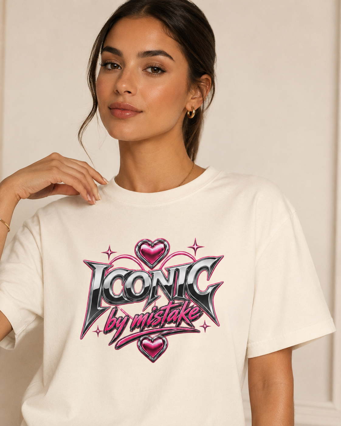 Woman wearing a white t-shirt with 'Iconic by mistake' design on a plain background