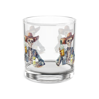 Clear glass tumbler with skeleton design holding a bottle