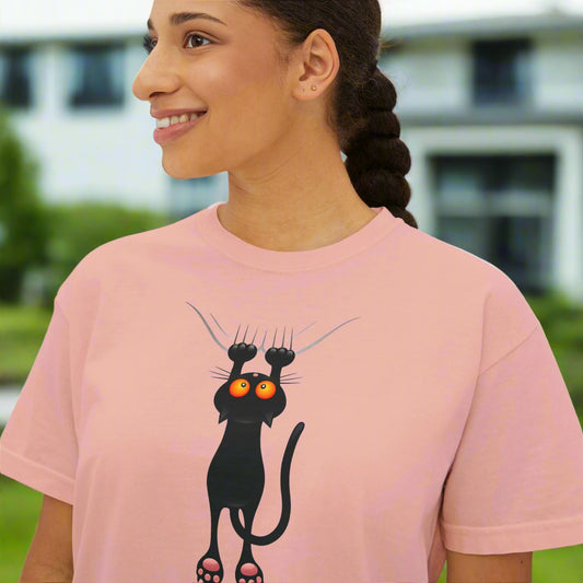 Person wearing a pink t-shirt with a black cat graphic
