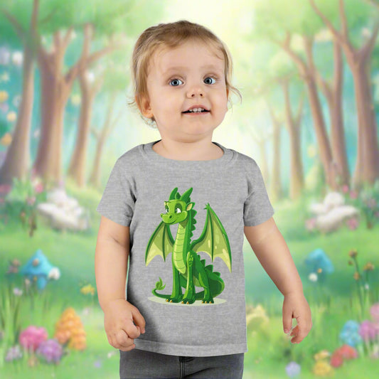 A toddler wearing a gray t-shirt with a cute green dragon graphic in the center.