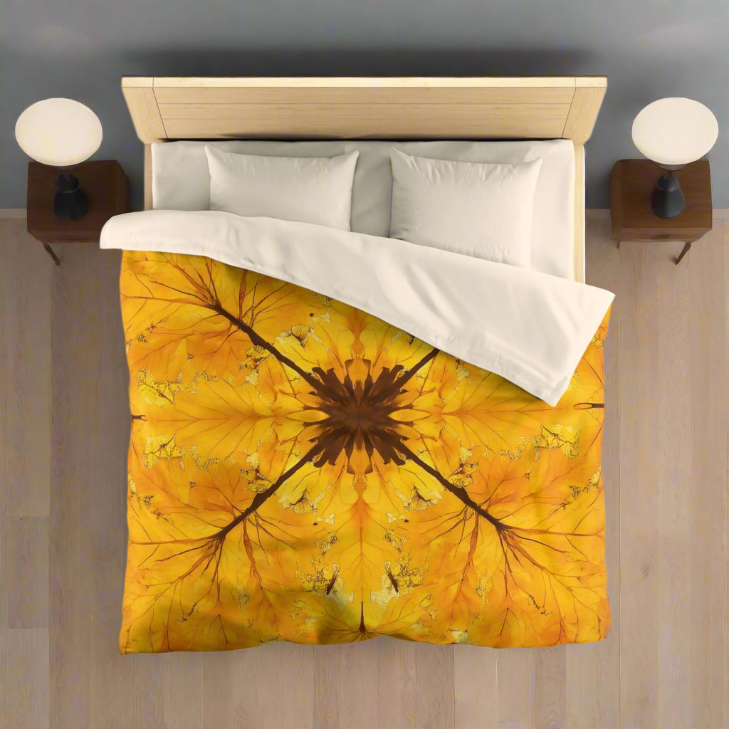 A duvet cover with a vibrant autumn leaf pattern, displayed on a bed with a white comforter and pillows.