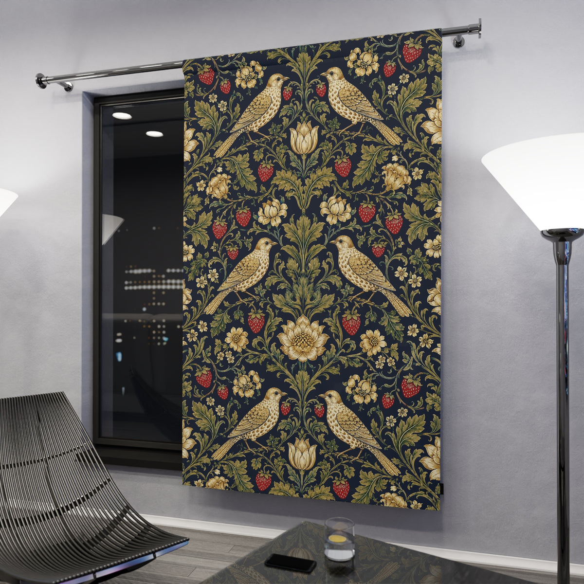 A long window curtain panel hanging on a metal rod in a modern room. The curtain features a dark navy blue background with a detailed floral and bird pattern in olive green, gold, and red.