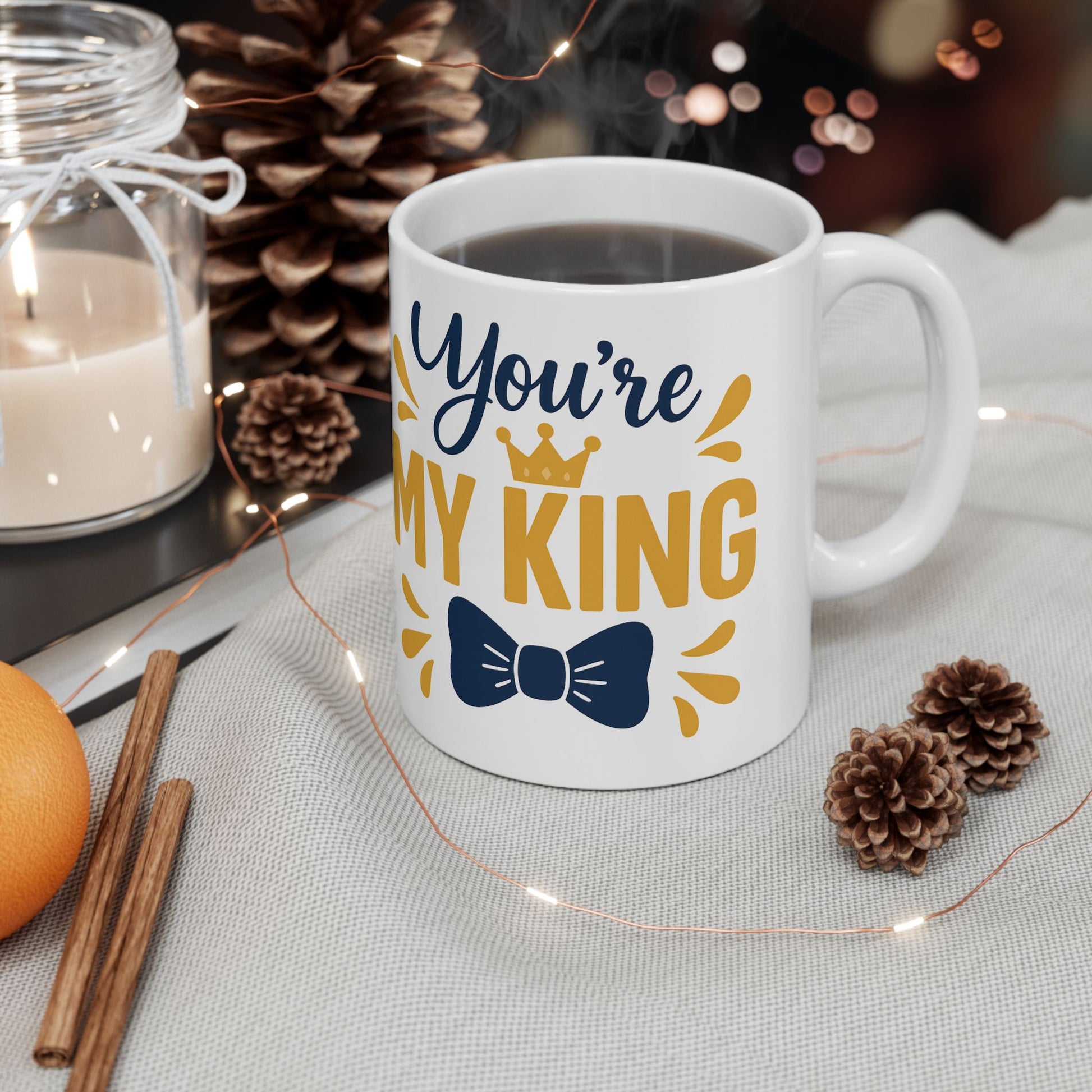 Mug with 'You're My King' text on a table with decorative items